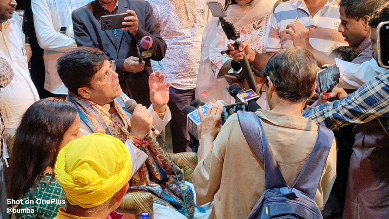 Debashish Dhar speaking to microphones